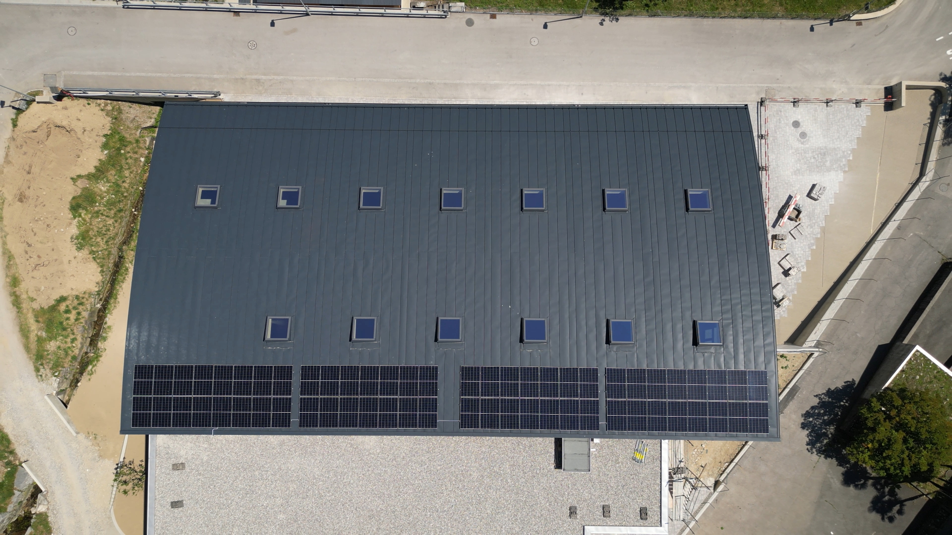 Top-down roof view with photovoltaic system and skylights